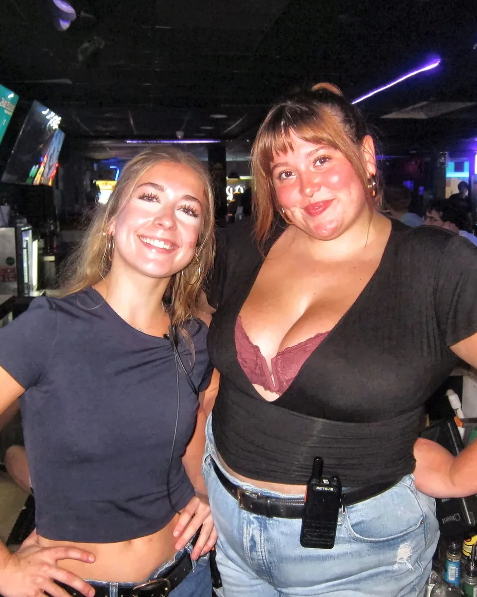 Two bartenders smiling inside Greene Street Pool Tavern.