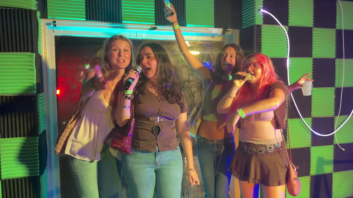 Friends singing karaoke together at Greene Street Pool Tavern in downtown Milledgeville.